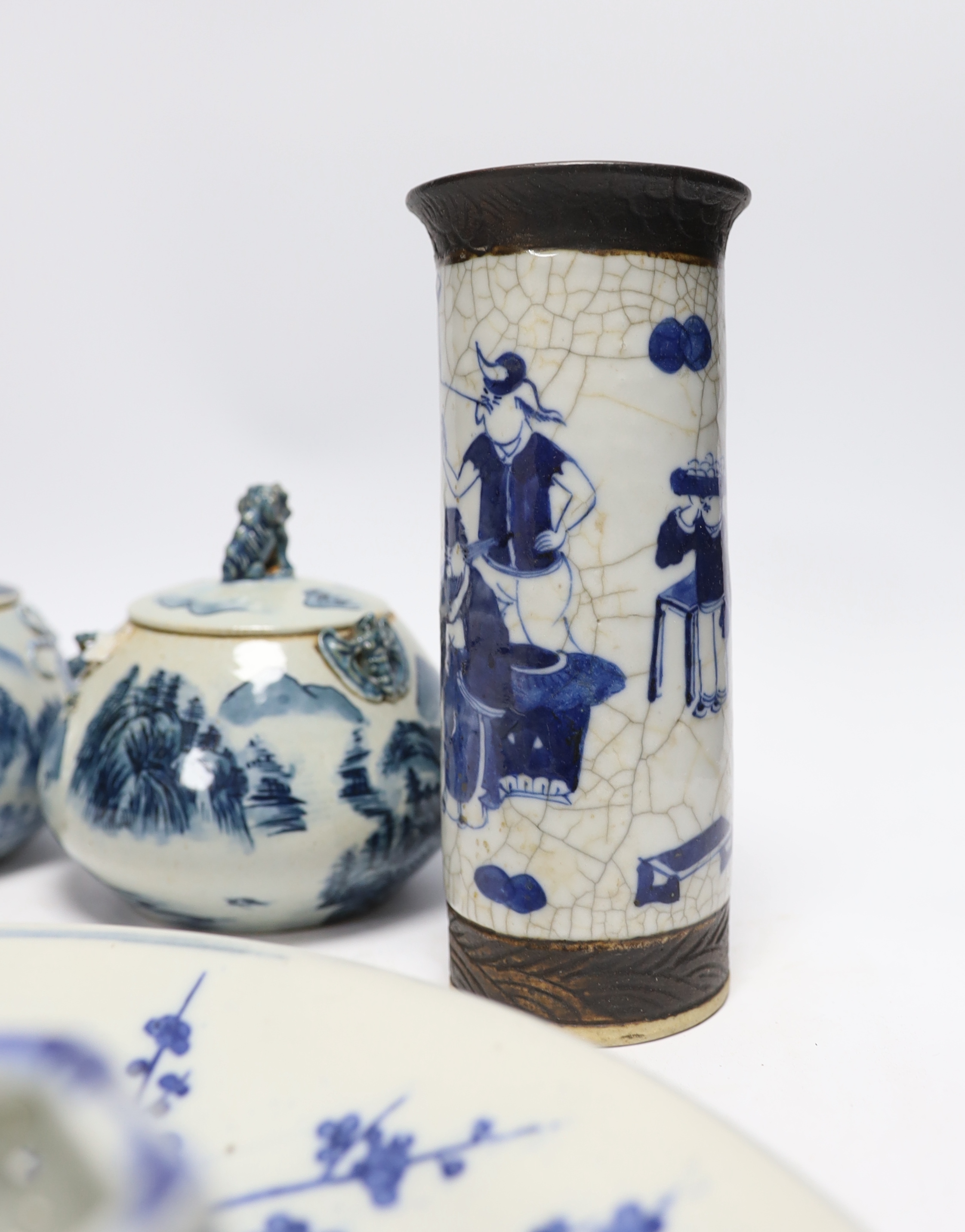 A Japanese blue and white wall plate, a pair of Chinese jars and covers, cylindrical crackle glaze vase and others, largest 31cm in diameter (7)